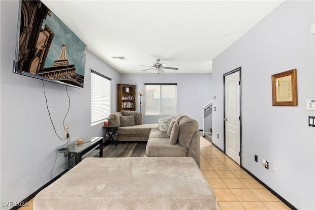 tiled living room with ceiling fan