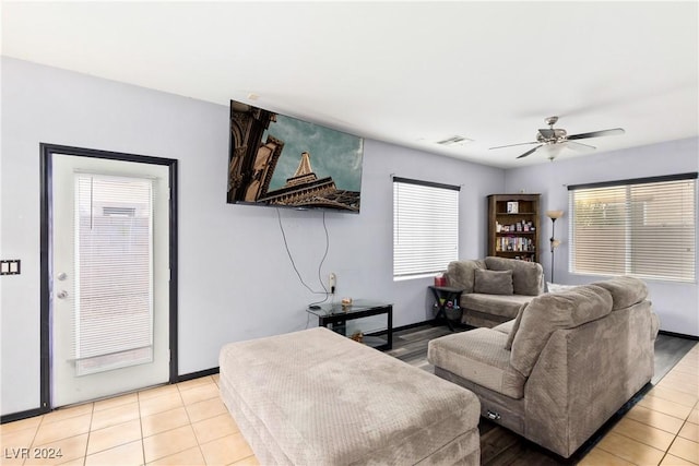 living room with ceiling fan and light tile patterned floors