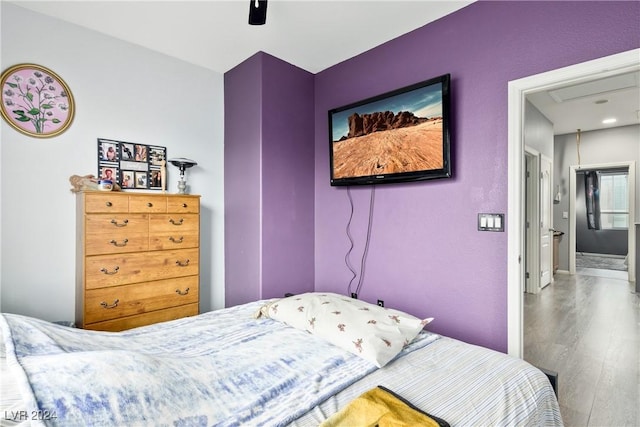 bedroom featuring connected bathroom, ceiling fan, and hardwood / wood-style floors