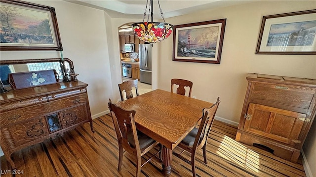 dining space featuring dark hardwood / wood-style floors