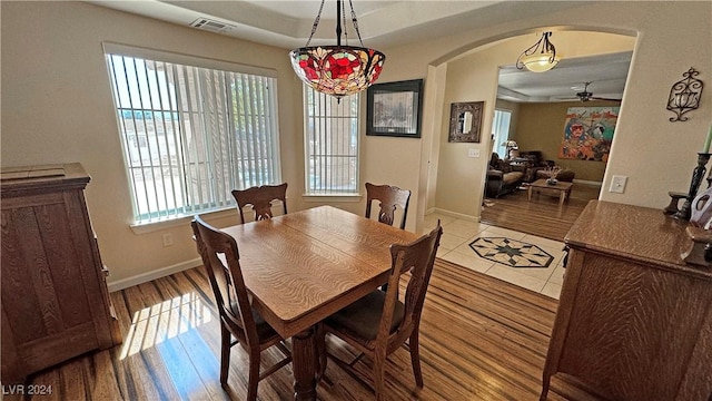 dining room with hardwood / wood-style flooring, plenty of natural light, and ceiling fan