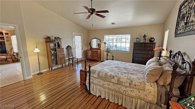 bedroom featuring ceiling fan, wood-type flooring, and vaulted ceiling