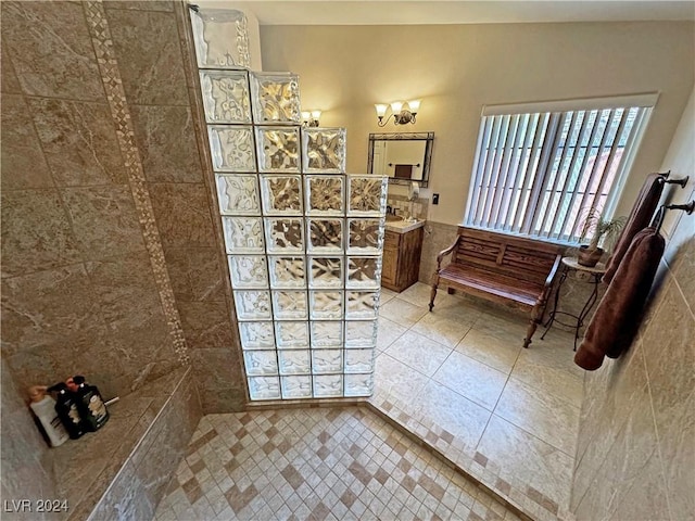 bathroom featuring tile patterned floors, vanity, and tiled shower