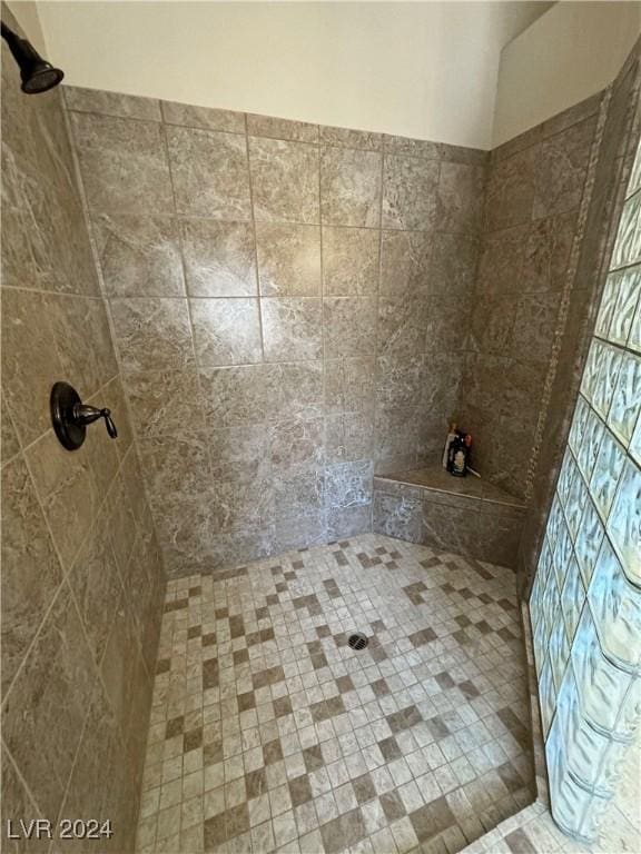 bathroom with a tile shower