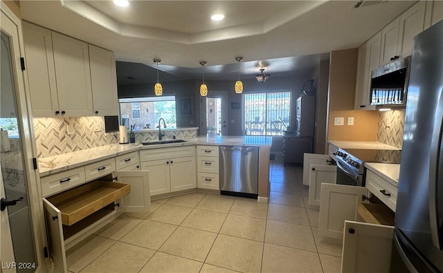 kitchen with white cabinets, pendant lighting, and appliances with stainless steel finishes