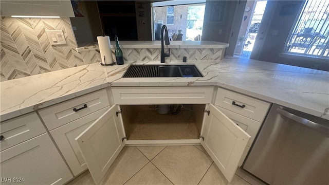 kitchen with white cabinetry, dishwasher, and sink