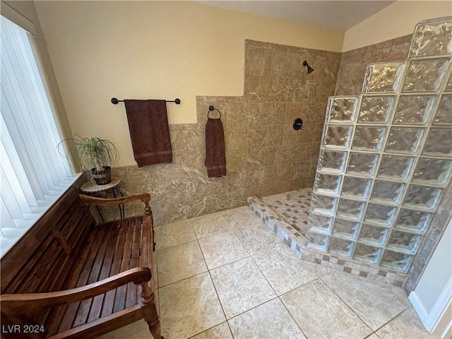 bathroom featuring a tile shower and tile patterned flooring