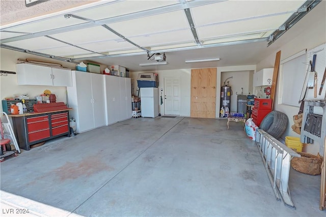 garage with white refrigerator, a garage door opener, and water heater