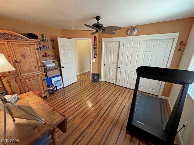 interior space with ceiling fan and wood-type flooring