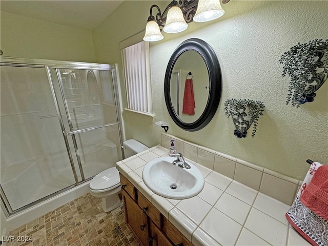 bathroom featuring vanity, toilet, and walk in shower