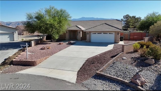 ranch-style house featuring a mountain view and a garage