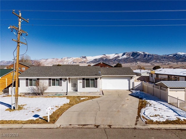 single story home with a mountain view and a garage