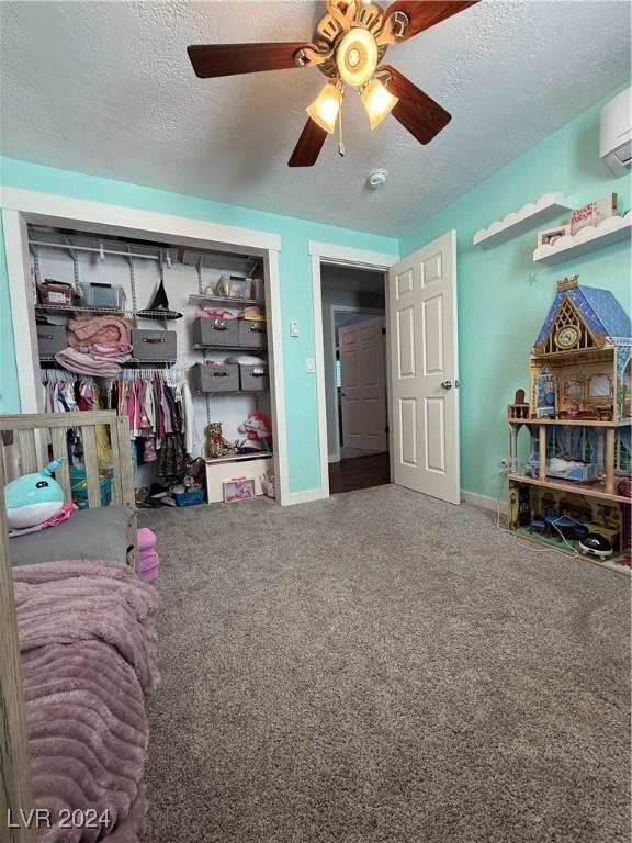 bedroom featuring carpet flooring, ceiling fan, and a textured ceiling