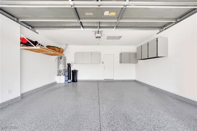 garage with a garage door opener and water heater