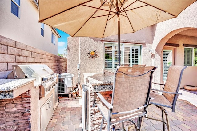 view of patio / terrace with area for grilling and central AC