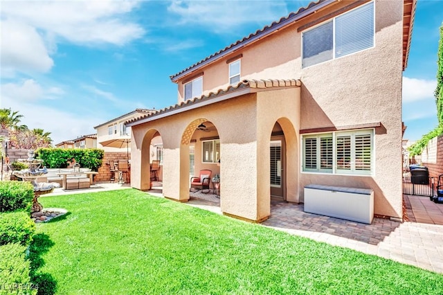 back of property featuring a yard and a patio area