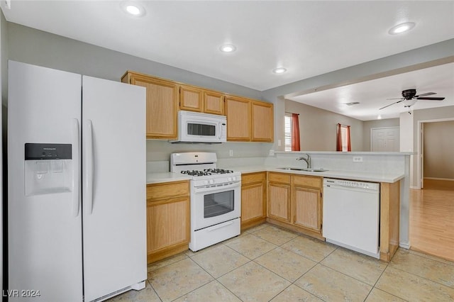 kitchen with light brown cabinets, white appliances, sink, ceiling fan, and kitchen peninsula