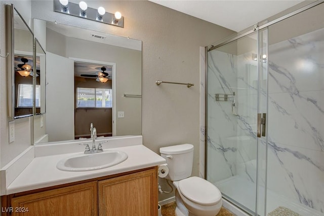 bathroom with ceiling fan, toilet, vanity, and walk in shower