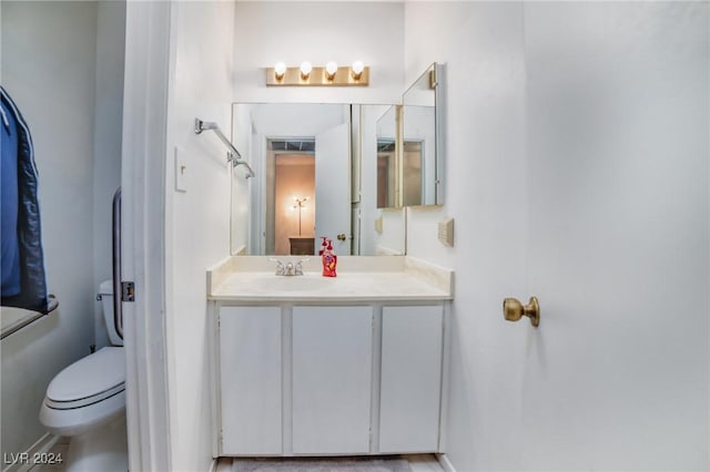 bathroom featuring vanity, wood-type flooring, and toilet