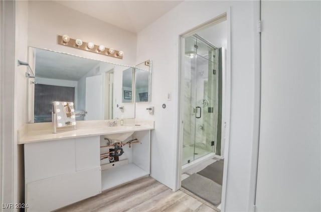 bathroom featuring hardwood / wood-style flooring and an enclosed shower