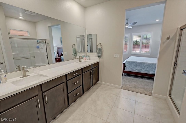 bathroom with ceiling fan, a shower with door, vanity, and tile patterned flooring