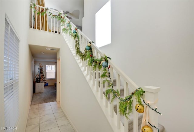 stairs featuring tile patterned flooring