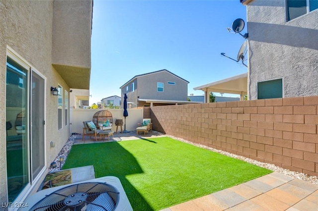 view of yard featuring a patio and central AC