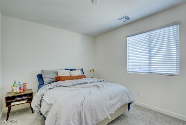 bedroom featuring light colored carpet