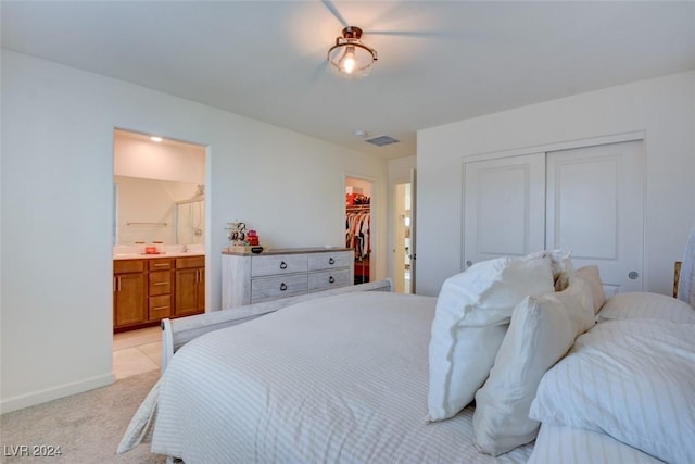 carpeted bedroom featuring ensuite bath