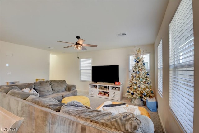 carpeted living room with a wealth of natural light and ceiling fan