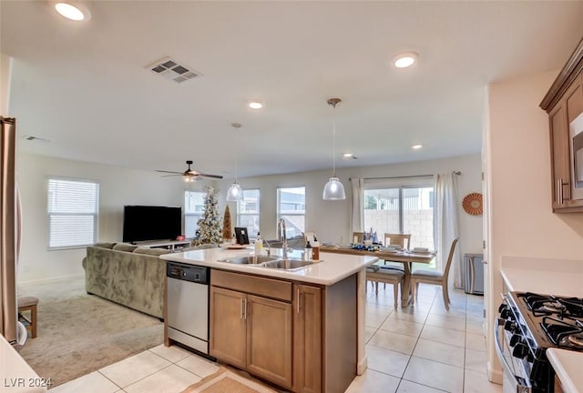 kitchen with light tile patterned flooring, appliances with stainless steel finishes, pendant lighting, and sink