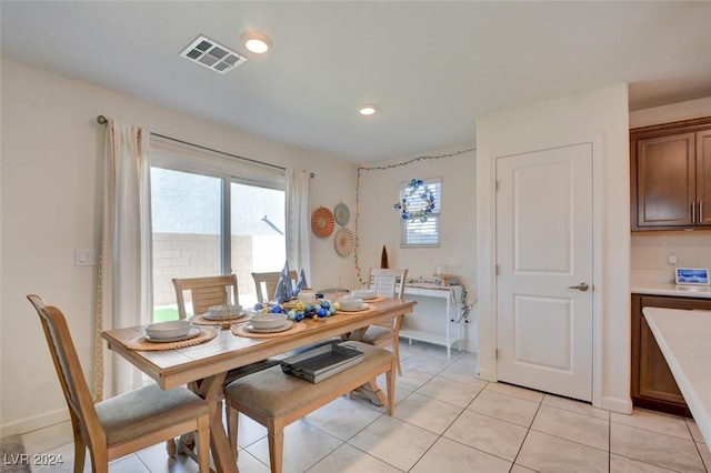 dining space featuring light tile patterned floors