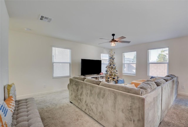 carpeted living room with ceiling fan