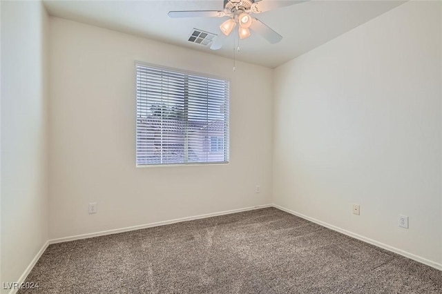 carpeted spare room featuring ceiling fan