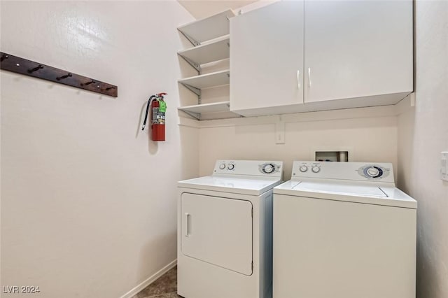 laundry room with washing machine and dryer, tile patterned flooring, and cabinets