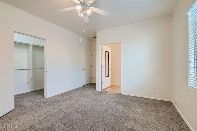 unfurnished bedroom featuring carpet, a closet, and ceiling fan