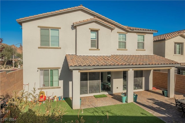 back of property with a patio