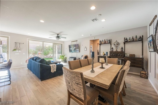 dining area featuring ceiling fan and light wood-type flooring