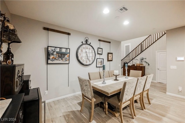 dining space with light hardwood / wood-style flooring