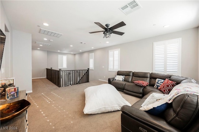 carpeted living room featuring ceiling fan