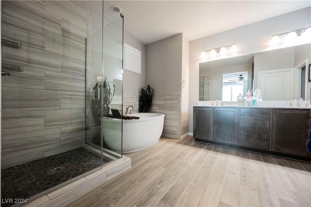 bathroom with independent shower and bath, vanity, and hardwood / wood-style floors