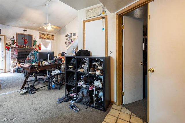 home office with ceiling fan, light carpet, and vaulted ceiling