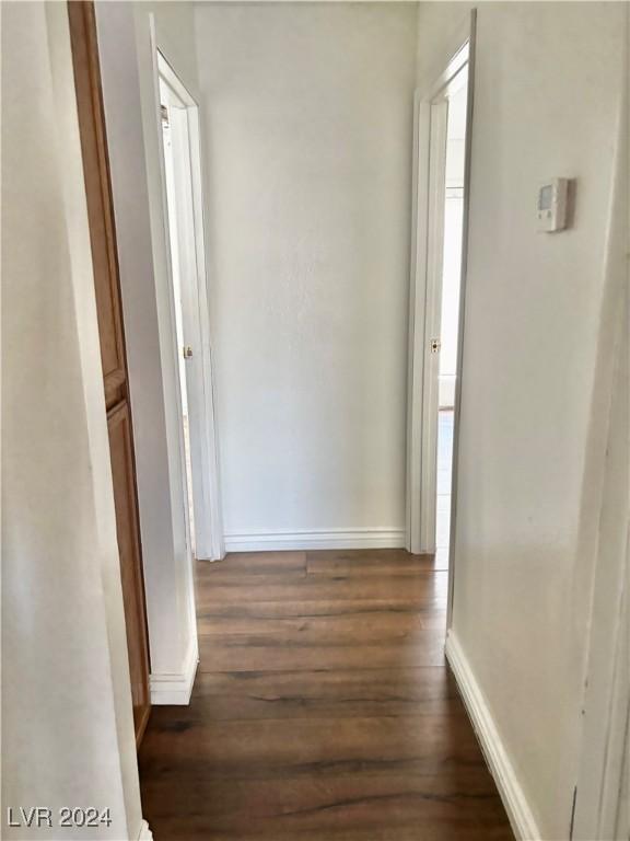 corridor featuring dark hardwood / wood-style flooring