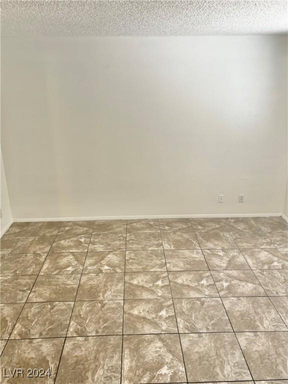 spare room with a textured ceiling