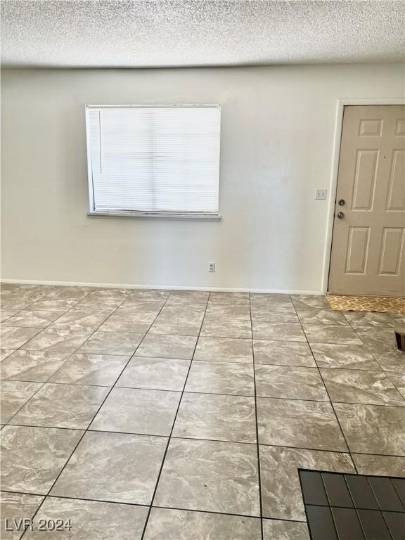 spare room with a textured ceiling
