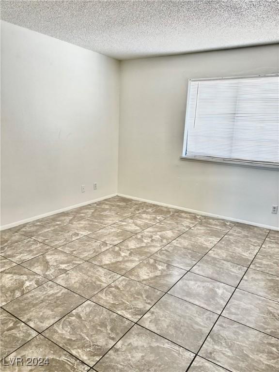 spare room featuring a textured ceiling