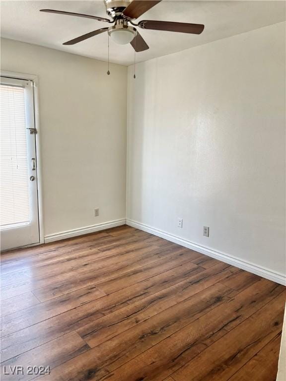 unfurnished room with dark hardwood / wood-style flooring and ceiling fan