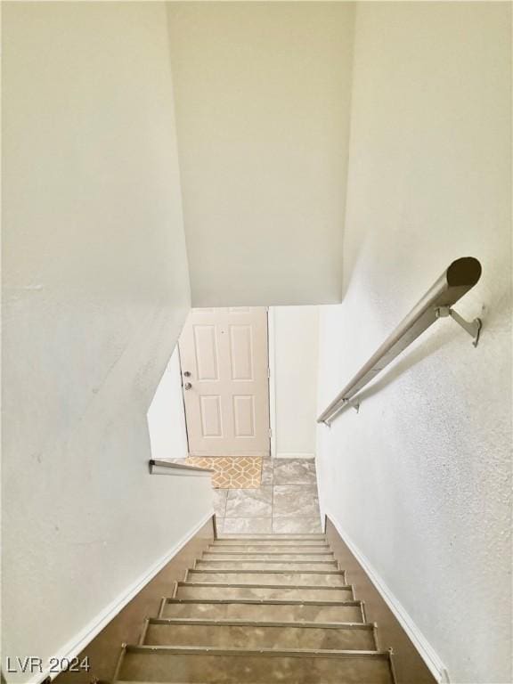 staircase with tile patterned flooring