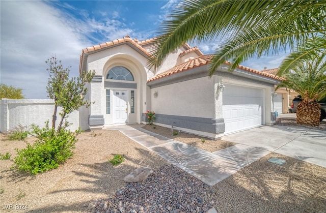 mediterranean / spanish-style house with a garage