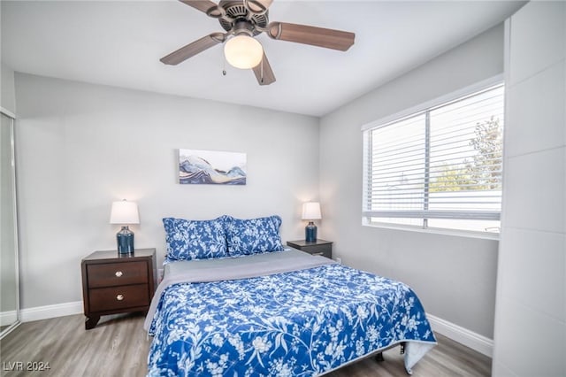 bedroom featuring hardwood / wood-style flooring and ceiling fan